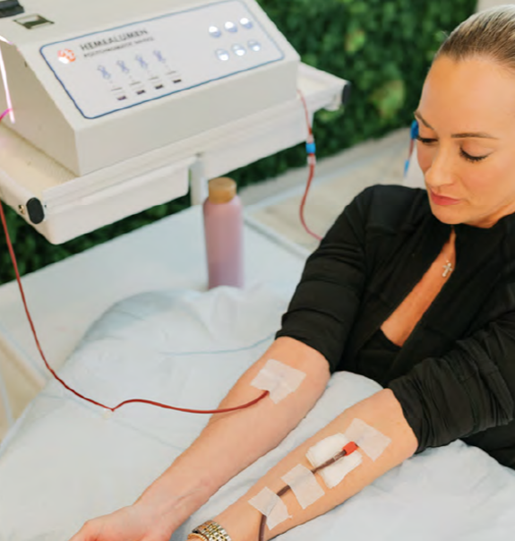 Woman Receiving EBO2 Ozone Therapy – BionwoRx Carmel IN Young woman comfortably receiving EBO2 Ozone Therapy through dual IV lines