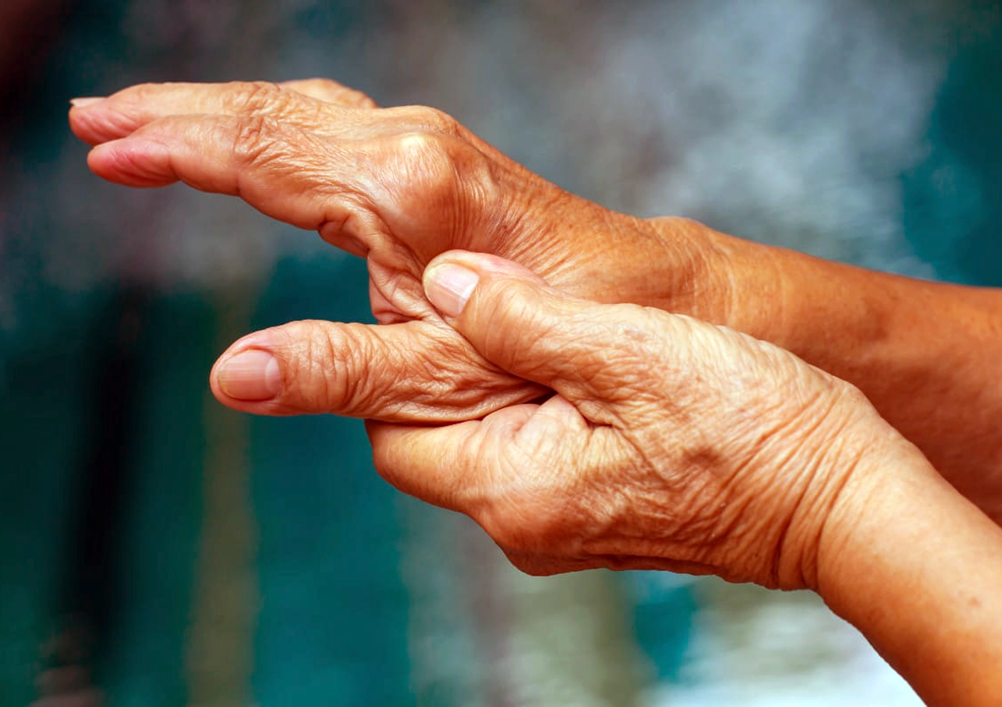 EBO2 Therapy Autoimmune Care Elderly Carmel Indiana Elderly person gently holding their own hand, symbolizing chronic pain, self-comfort, and autoimmune disease management at BionwoRx in Carmel, Indiana