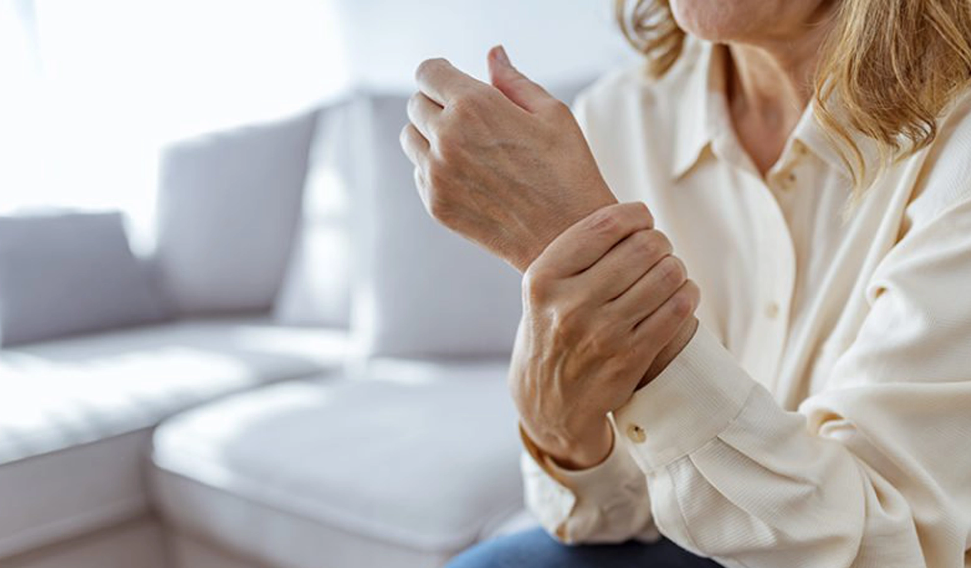 Woman holding her wrist due to joint inflammation, representing chronic inflammation and the need for medical detox therapy in Carmel Indiana at BionwoRx.
